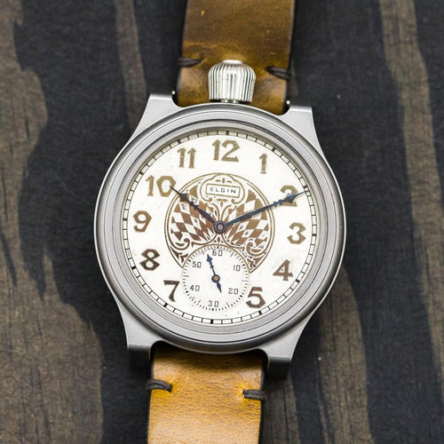 Close up of a watch, titanium case, ornate dial, brown leather strap. 