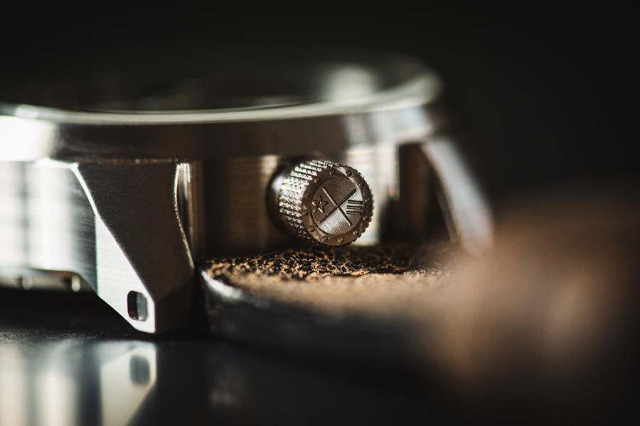 Close up of a watch crown, stainless steel. 