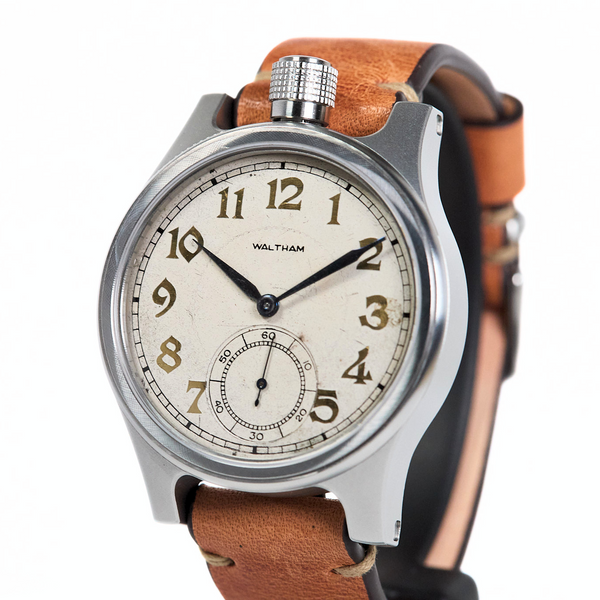Watch with brown leather strap and silver case on white background