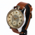 A vintage-style wristwatch with a round silver-toned case, cream-colored dial, black numerals, and a brown leather strap, shown on a plain white background.