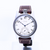 Watch with a brown leather strap on a white background