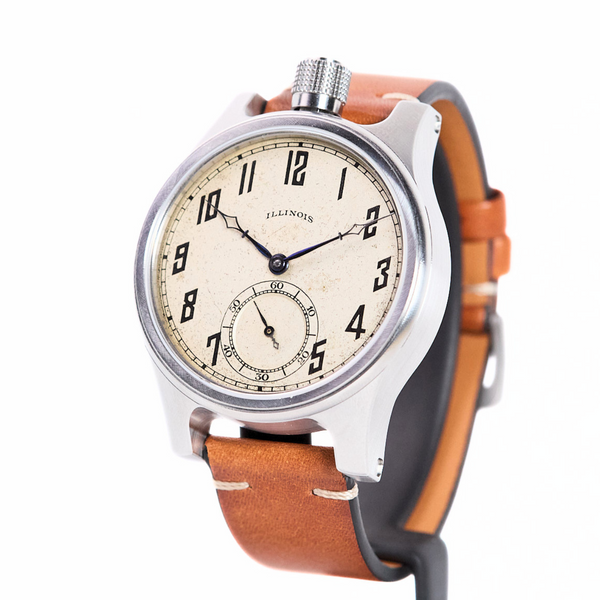 Watch with brown leather strap and beige dial on a white background