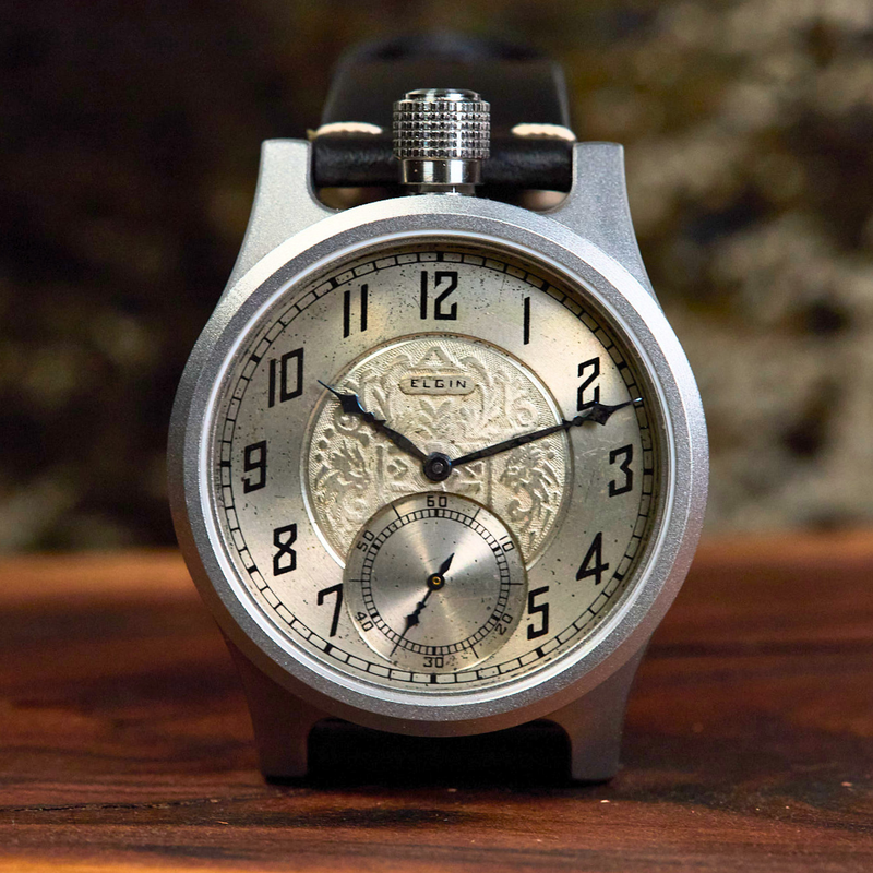Vintage-style wristwatch with intricate design on a wooden surface