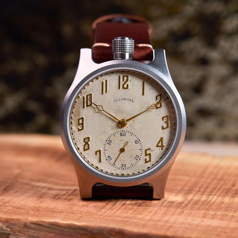Vintage pocket watch on a wooden surface with a blurred natural background