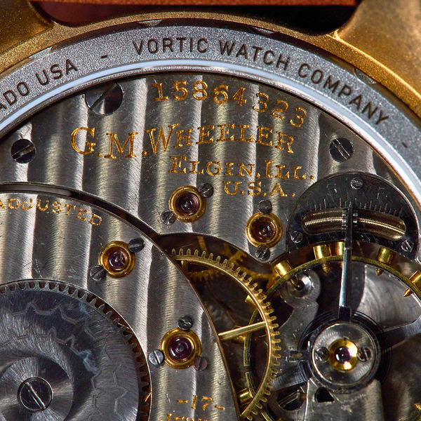 Close-up of a watch mechanism with visible branding and text.