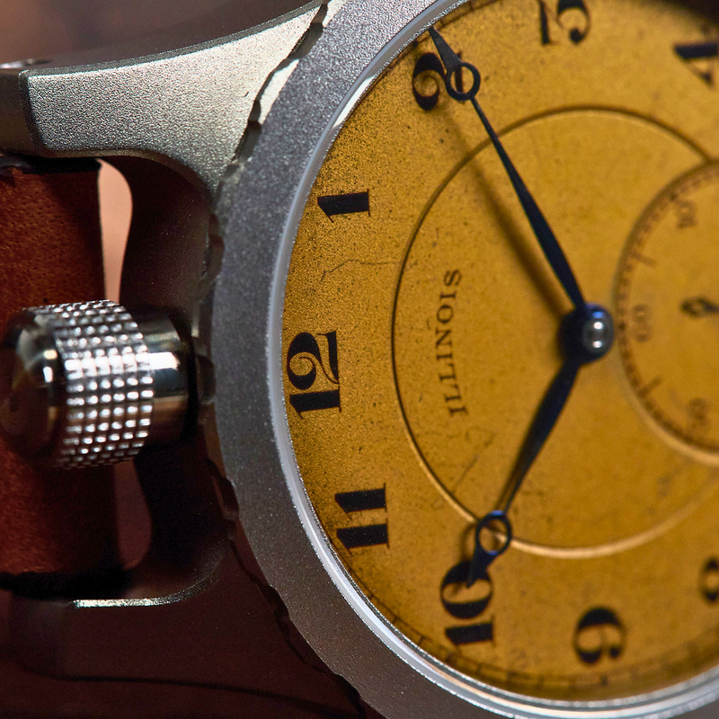 Close-up of a Sigenti watch with a textured brown leather strap, a silver-toned case, and a warm yellow dial featuring black Arabic numerals and a small subdial.