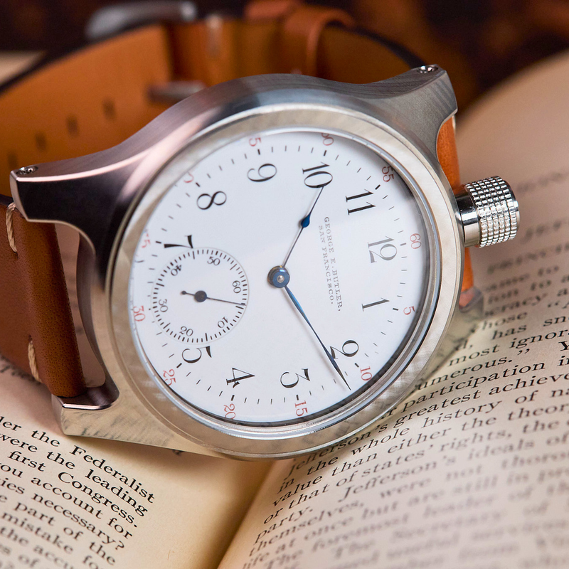 Watch with a brown leather strap on an open book