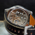 Mechanical watch with open face showing intricate gears on a dark background