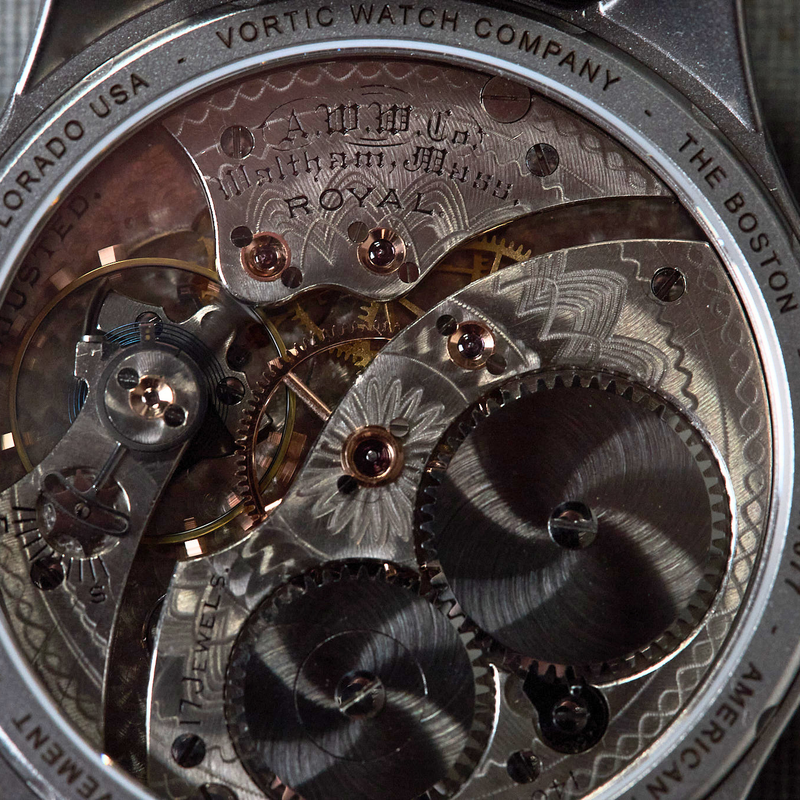 Close-up of the open back of a Vortic Watch Company Royal automatic watch, showing the detailed mechanical movement with gears and bridges.